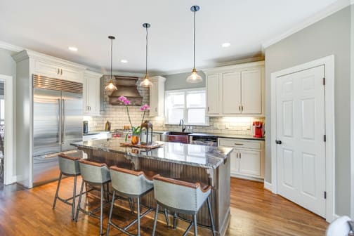 A Character Maple and Maple Kitchen featuring Hanover Inset and Henlow Square Inset cabinet doors in Drift Java and Gray Mist from Wellborn Cabinet, Inc.