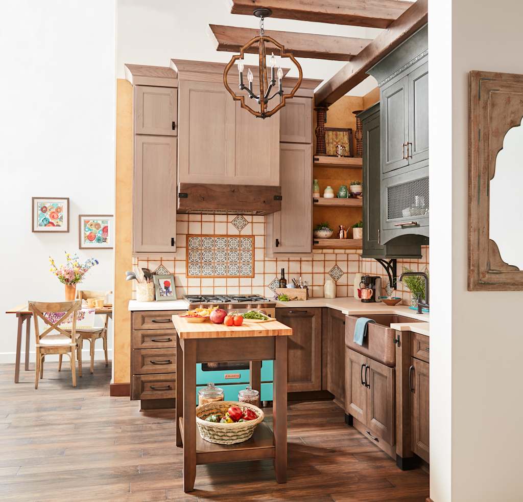 full overlay cabinets in kitchen with small island table and blue stove