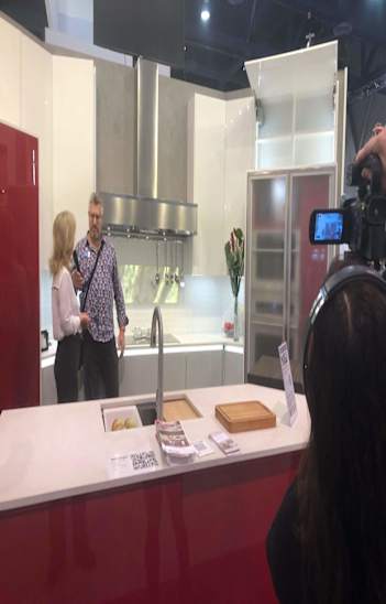 angela o'neill interviewing with press at the kitchen and bath industry show