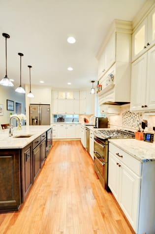 A Medium Density Fiberboard Kitchen featuring Bedford Square and Camden Square cabinet doors in Divinity and Sienna from Wellborn Cabinet, Inc.