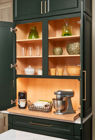 These Green and Dark cabinets for the 2022 Exhibit Booth home were provided by Wellborn Cabinet, Inc.