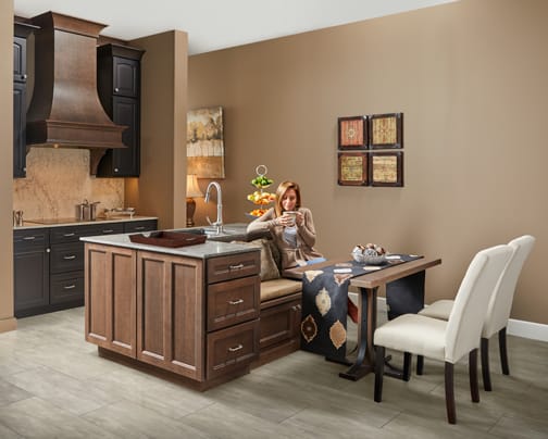 A Oak and Cherry Kitchen featuring Millbrook Square and Bedford Arch cabinet doors in Drift Slate and Shadow from Wellborn Cabinet, Inc.