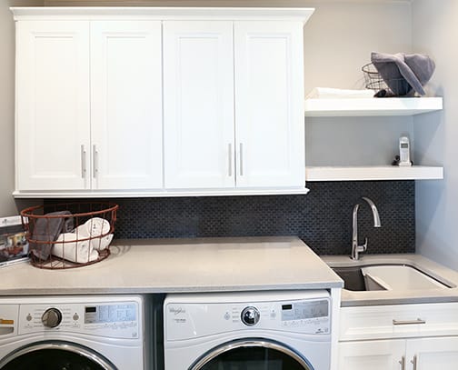 A Maple Laundry Room featuring Chelsea cabinet doors in Glacier Pewter from Wellborn Cabinet, Inc.