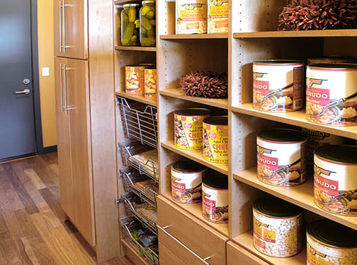 A Maple Pantry featuring Milan cabinet doors in Ginger from Wellborn Cabinet, Inc.