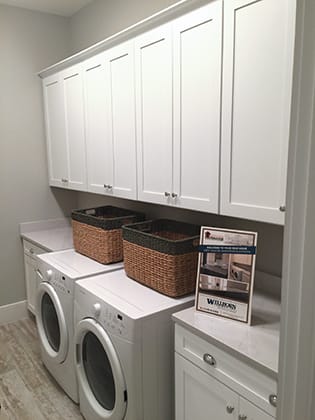 A Medium Density Fiberboard Laundry Room featuring Hancock cabinet doors in Glacier from Wellborn Cabinet, Inc.