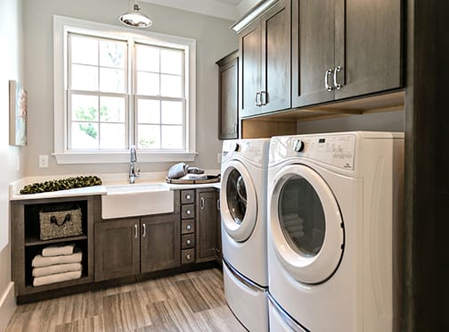 A Maple Laundry Room featuring Prairie cabinet doors in Drift from Wellborn Cabinet, Inc.