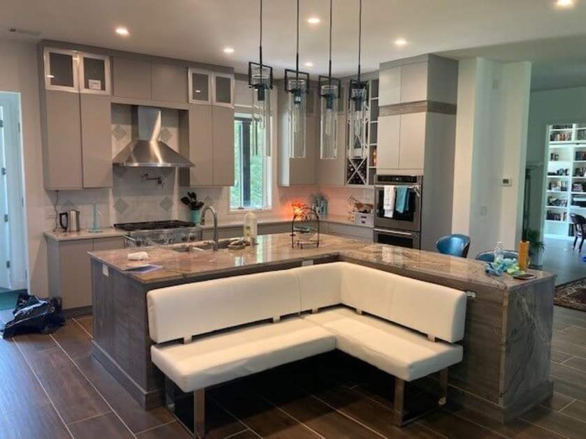 kitchen with light gray cabinets with bar seating bench