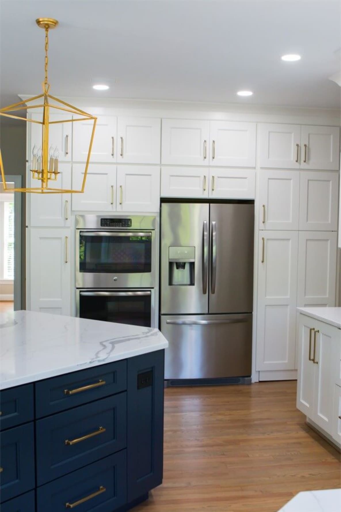 kitchen with tall white cabinets and blue island