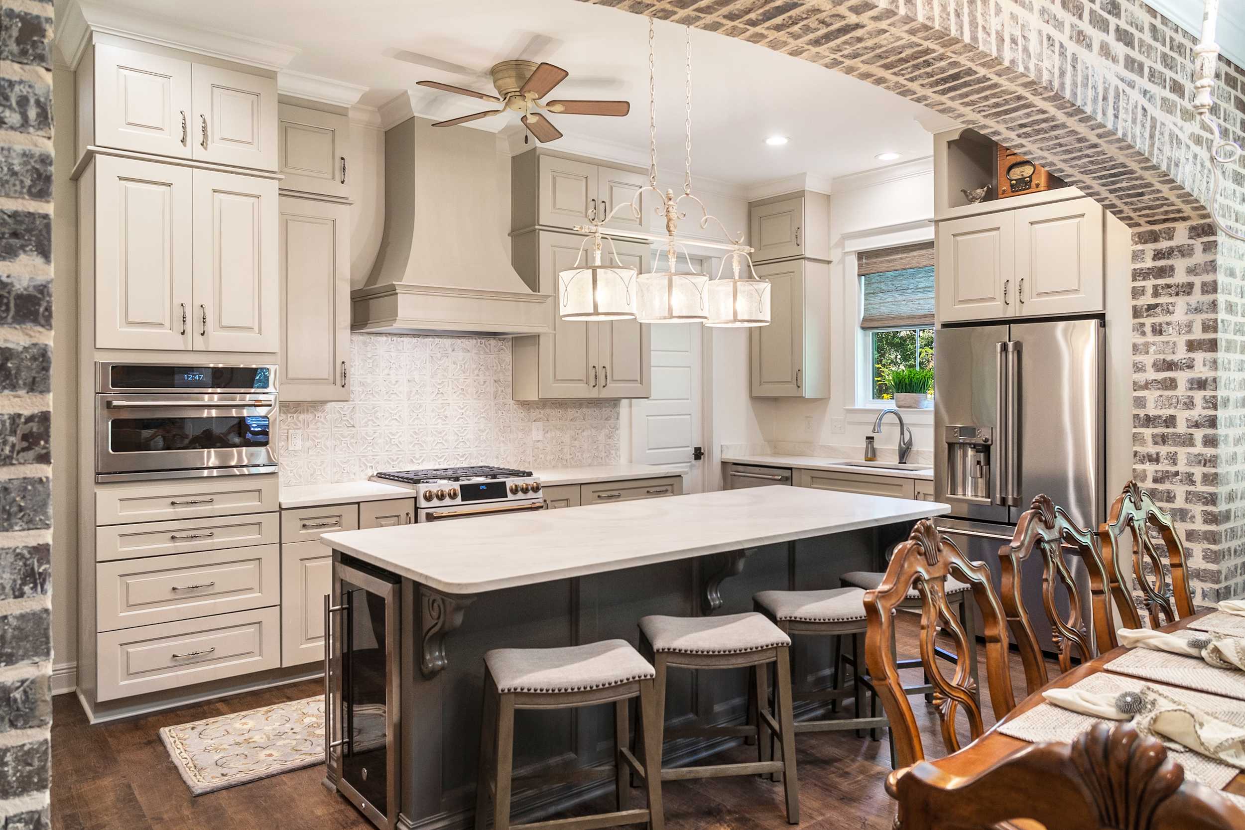 A Medium Density Fiberboard Kitchen featuring Trestle cabinet doors in Gray Mist and Mink Gray from Wellborn Cabinet, Inc.