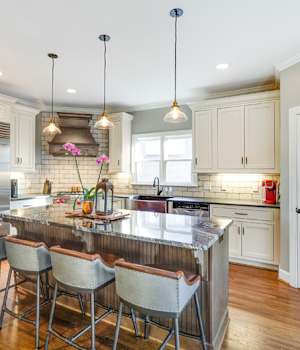 A Character Maple and Maple Kitchen featuring Hanover Inset and Henlow Square Inset cabinet doors in Drift Java and Gray Mist from Wellborn Cabinet, Inc.