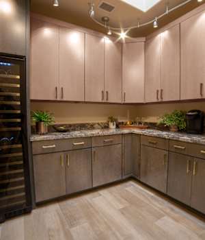 A Maple Hutch and Refreshment Areas featuring Milan cabinet doors in Drift and Oatmeal from Wellborn Cabinet, Inc.
