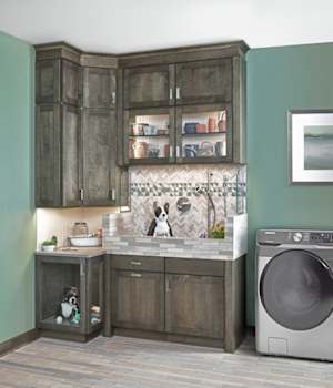 A Maple Laundry Room and Pet Suites featuring Hanover cabinet doors in Ash from Wellborn Cabinet, Inc.
