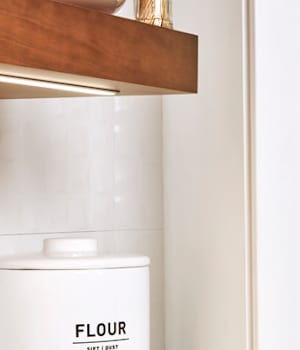 These Light and White cabinets for the 2021 Exhibit Booth home were provided by Wellborn Cabinet, Inc.