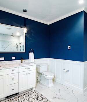 A Medium Density Fiberboard Bath featuring Trestle cabinet doors in Bright White from Wellborn Cabinet, Inc.
