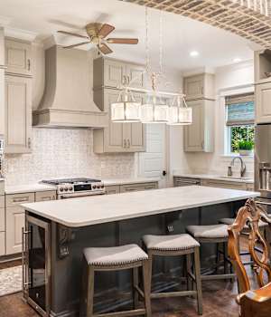 A Medium Density Fiberboard Kitchen featuring Trestle cabinet doors in Gray Mist and Mink Gray from Wellborn Cabinet, Inc.