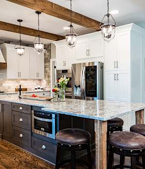 A Medium Density Fiberboard and Maple Kitchen featuring Prairie and Saybrook cabinet doors in Drift and Glacier from Wellborn Cabinet, Inc.