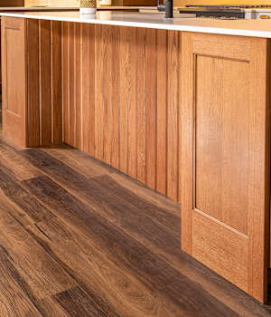 A Oak, Cherry, and Medium Density Fiberboard Kitchen featuring Wyatt cabinet doors in River Rock Charcoal, Peppermill, and Alabaster from Wellborn Cabinet, Inc.