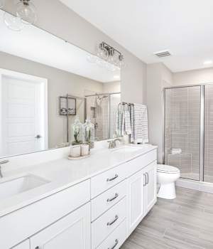 A Maple Bath featuring Lexington cabinet doors in Oyster White from Wellborn Cabinet, Inc.