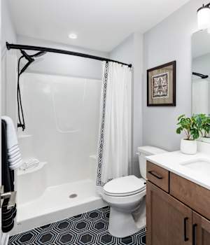 A Maple Bath featuring Galena Square cabinet doors in River Rock from Wellborn Cabinet, Inc.