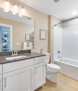 A Maple Bath featuring New Haven cabinet doors in Bright White from Wellborn Cabinet, Inc.