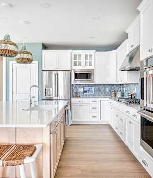 A Medium Density Fiberboard and Maple Kitchen featuring Galena Square cabinet doors in Boardwalk and Aqua from Wellborn Cabinet, Inc.