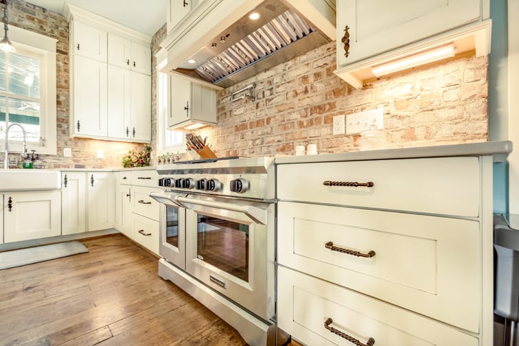 A Character Maple Kitchen featuring Hanover cabinet doors in Divinity Java from Wellborn Cabinet, Inc.