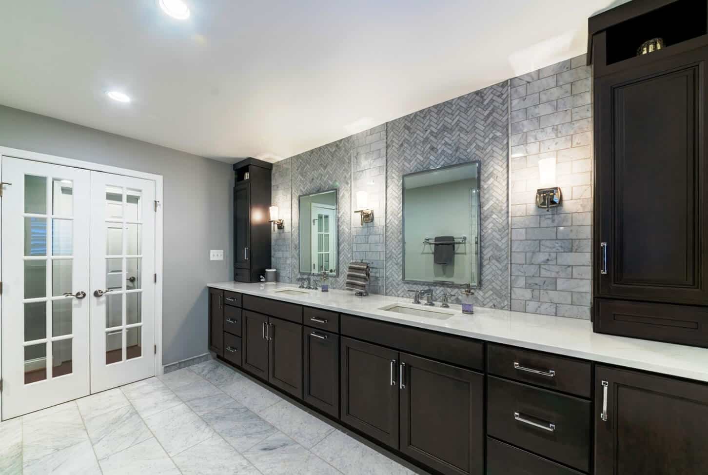 long brown vanity cabinet with two tall wall cabinets on each end