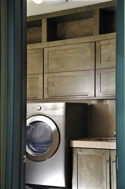 A Maple Laundry Room featuring Sandia cabinet doors in Evergreen Java from Wellborn Cabinet, Inc.